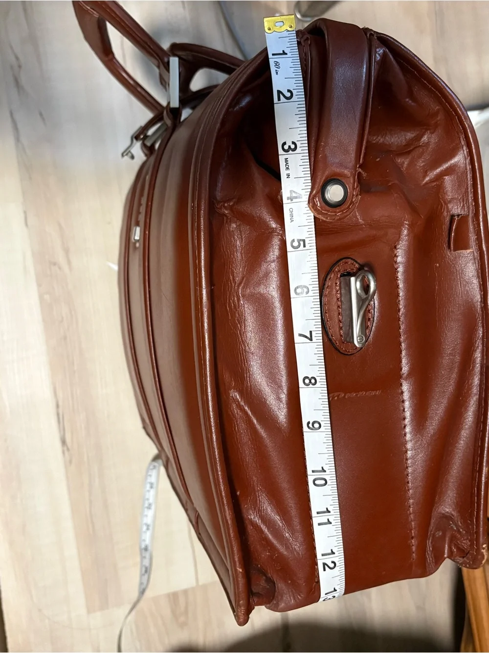 Litagator leather briefcase with security features and sturdy handles.